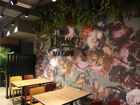 The Flower Bar Café interior at the Duke Shopping Mall, Victoria, Gozo, showing floral mural and seating area.